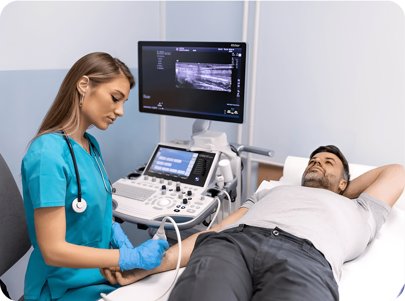 Medical professional performing ultrasound on patient's arm.